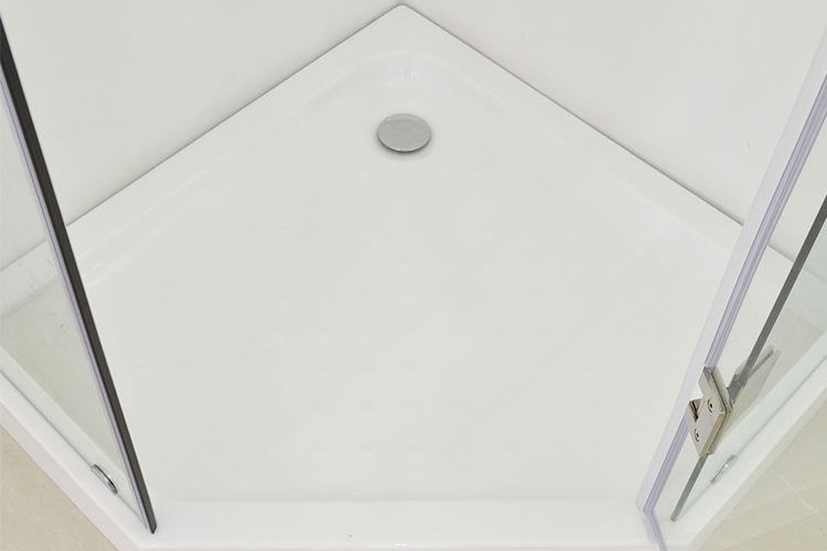 Top view of a white corner shower tray with central chrome drain and glass door panels with metal hinges