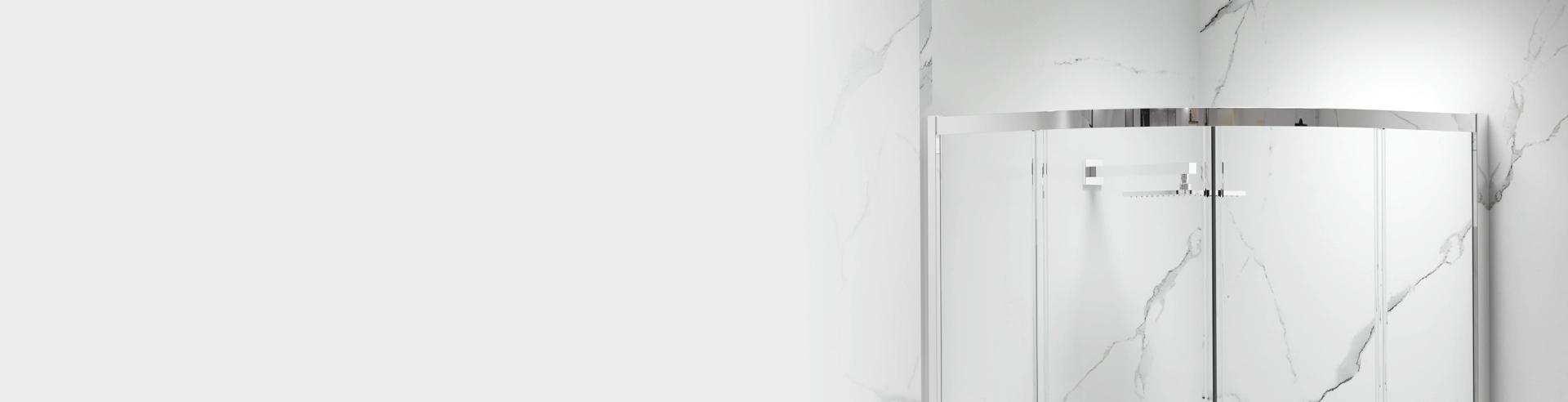 Three-panel curved glass shower enclosure with chrome top bar and rain showerhead against marble walls, banner image