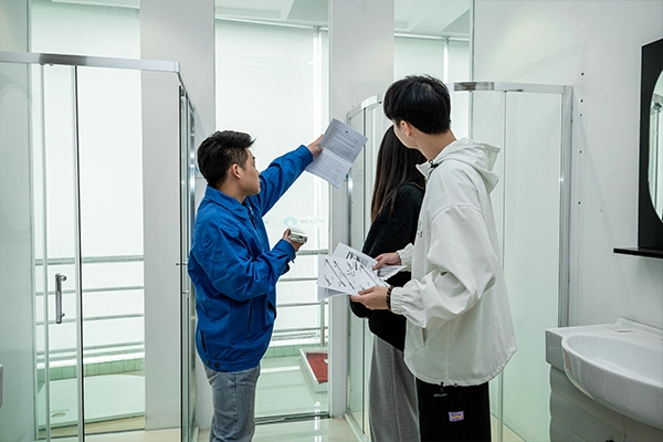 three people checking the quality of shower enclosure