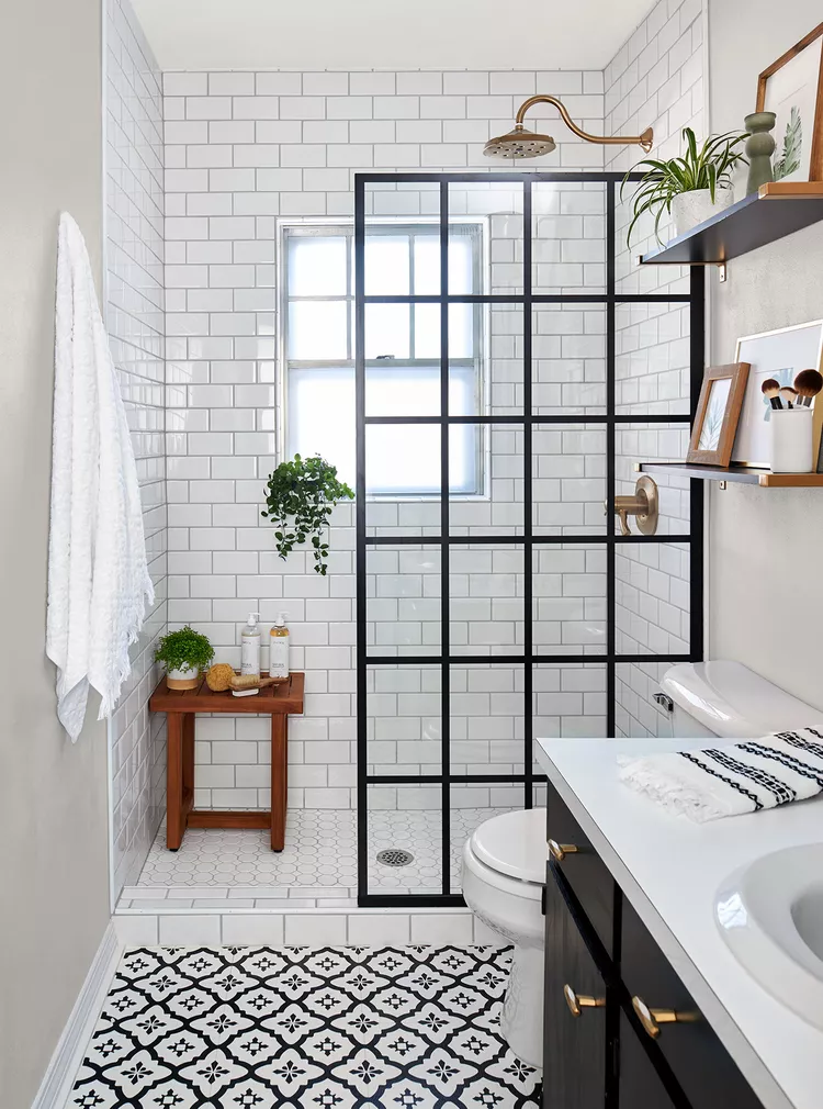 a framed shower door in the bathroom