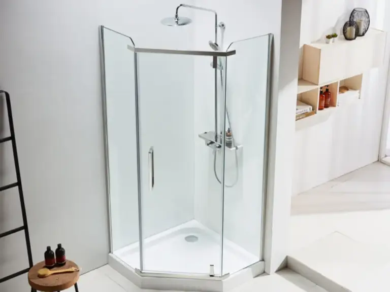 Hexagonal corner shower enclosure with clear glass panels, chrome frame, rainfall showerhead and white shower tray