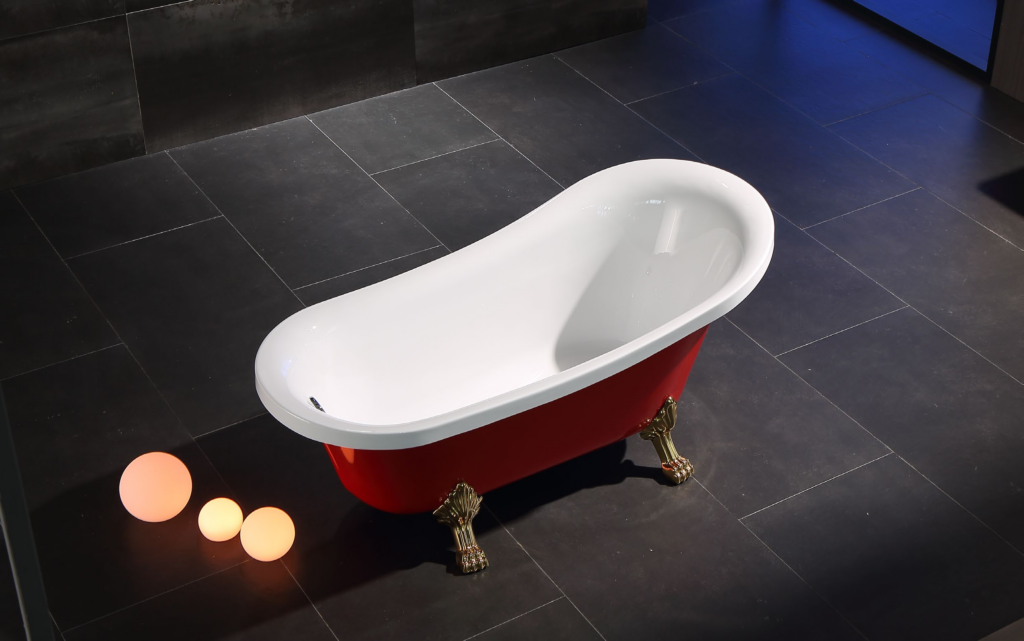 Red freestanding clawfoot bathtub EE670 with white interior, gold paw feet and warm LED sphere lamps on dark tile floor