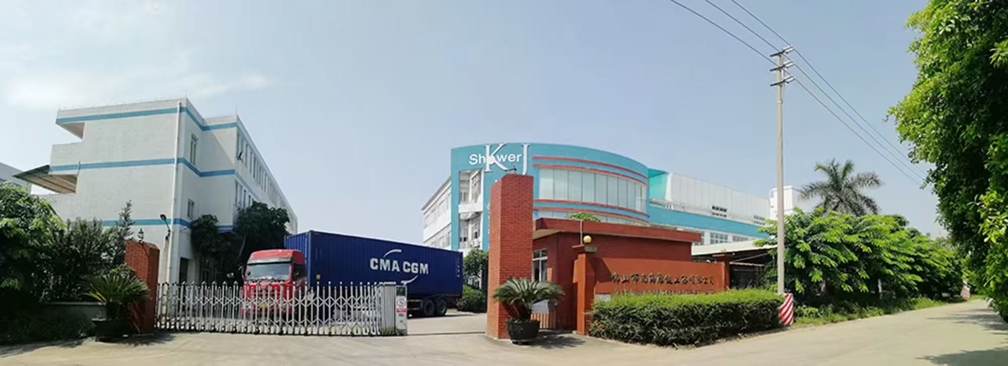 KJbath factory entrance with Shower KJ building signage and a container truck loading certified shower glass for export