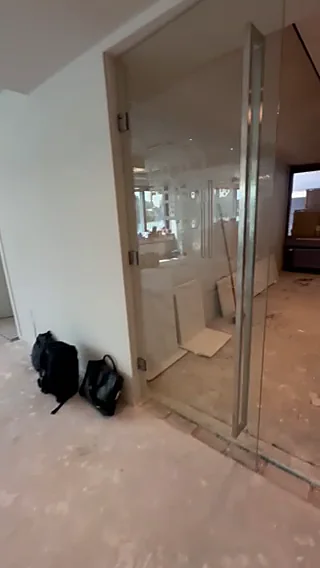 Glass office door with metal frame installed on site at the Dar es Salaam office building, Tanzania