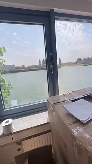 Office interior with installed aluminum window framing the outdoor view, Tanzania commercial project